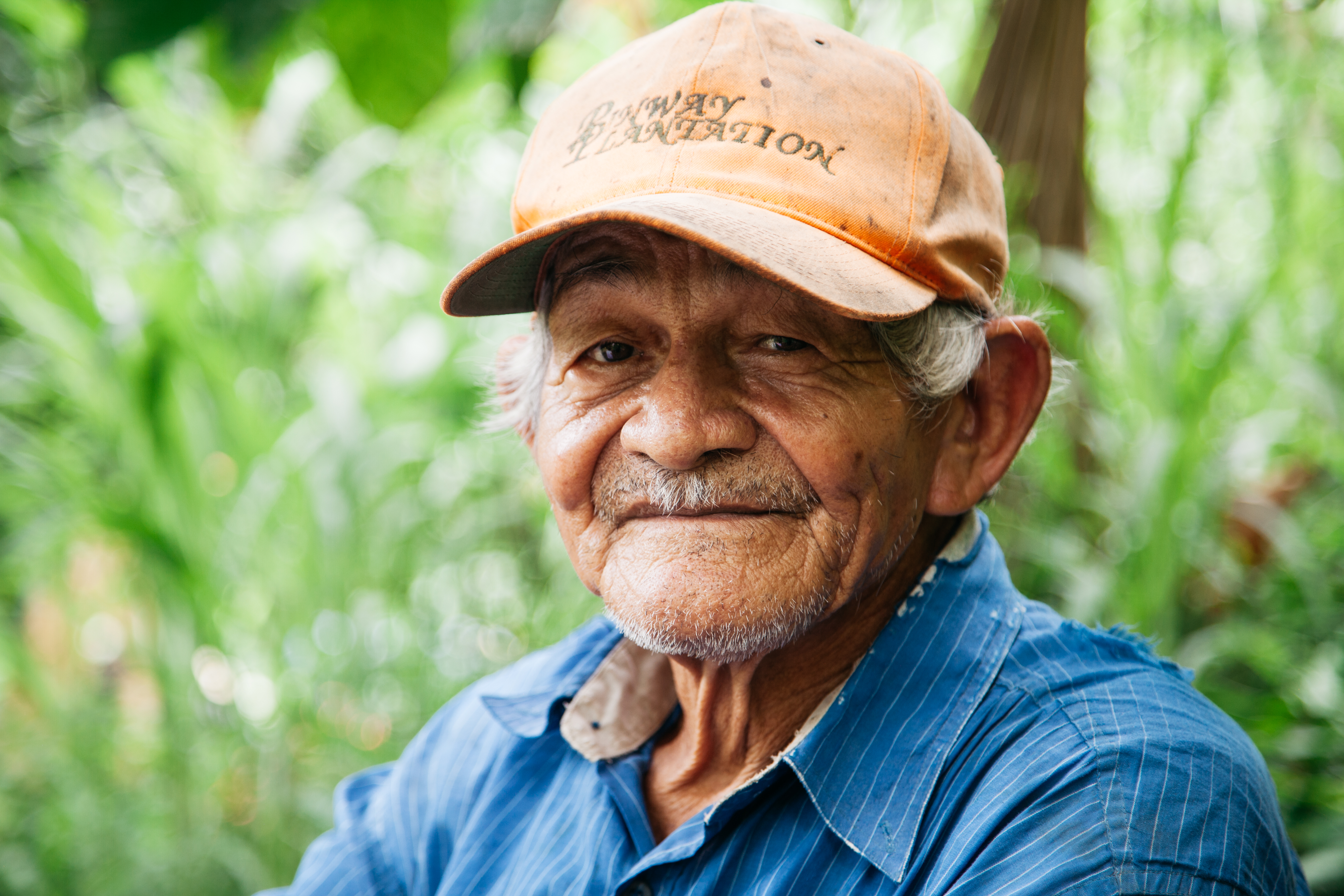 A close-up potrait of the wrinkled face of a male cocoa farmer from Honduras
