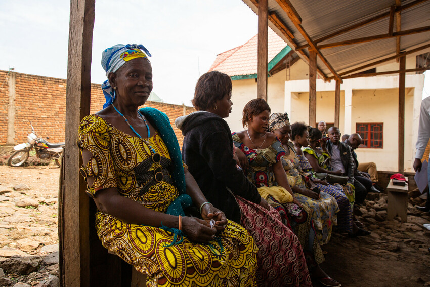 Eventina Kahuranyi waits for a meeting of her village savings and loan association to begin.