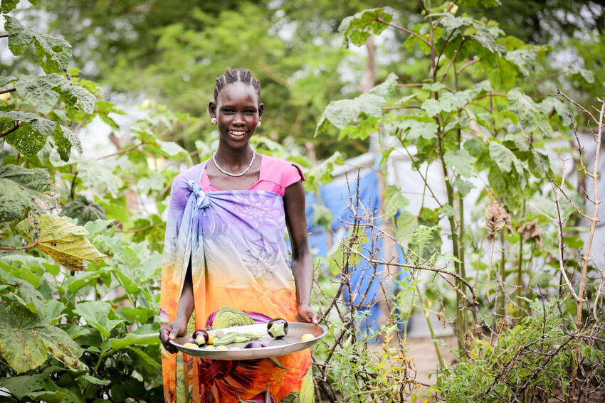 Woman holding vegetables from her garden