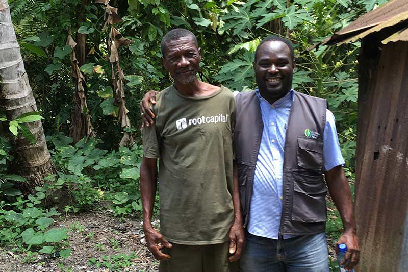 San Martin "Fe-Fe" Fasic (left) is a cacao farmer nearby who plans to take part in a field training for farmers. He stands with Luc Maille LeFranc, LWR's country director for Haiti