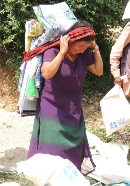 A woman leaves an LWR Mission Quilt distribution in Nepal's Lalitpur District after the April 2015 earthquakes [Photo: Carrie Taneyhill]