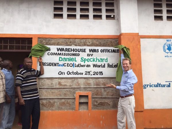 LWR president Daniel Speckhard stands in front of a crop storage facility that was built as a part of an LWR project.