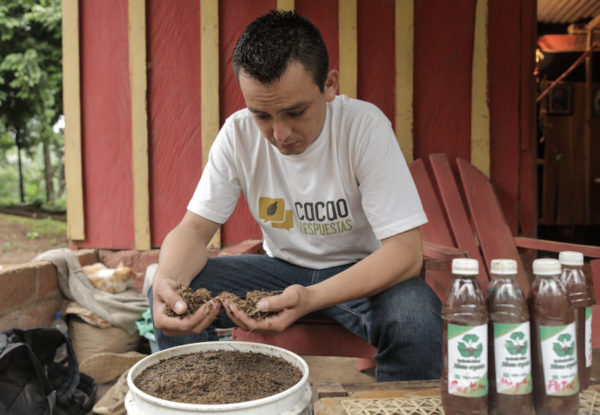 Cesar Lopez works with the fertilizer he produces using the skills he learned in the Cocoa diploma project.