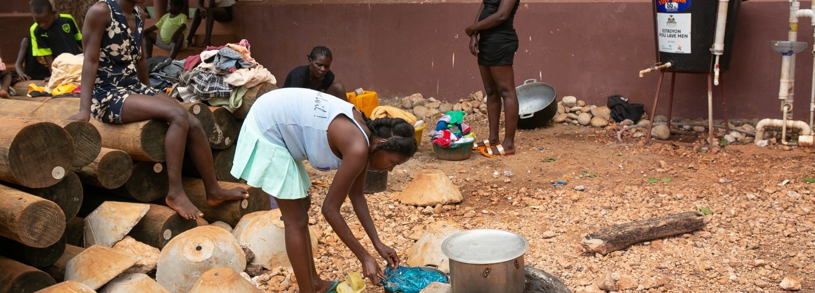 Haitian community members perform daily tasks. 