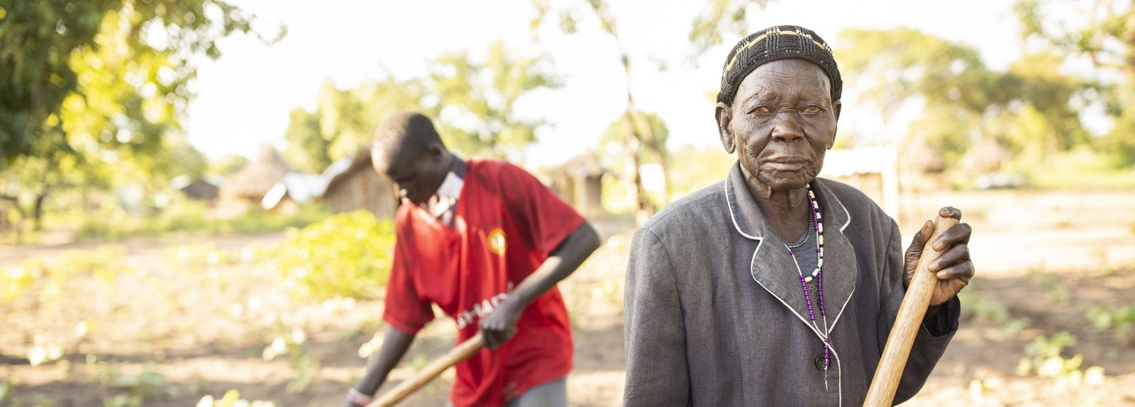 Philip Bidal, 17, and his grandmother, Acii Paulina, who is in her 80s, are refugees from South Sudan living in Palabek Refugee Settlement in northern Uganda. They received improved seeds and agricultural training from Lutheran World Relief to help diversify their diet and increase their income. (Photo by Jake Lyell)