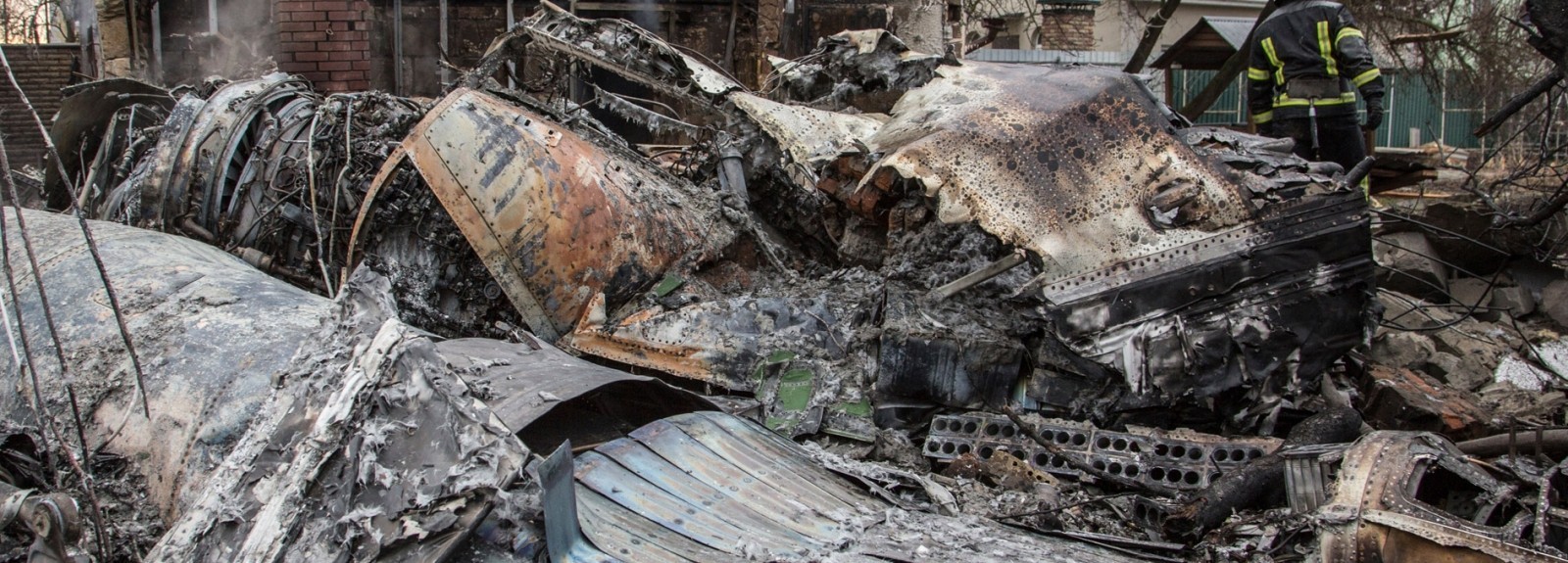 A firefighter walks through rubble