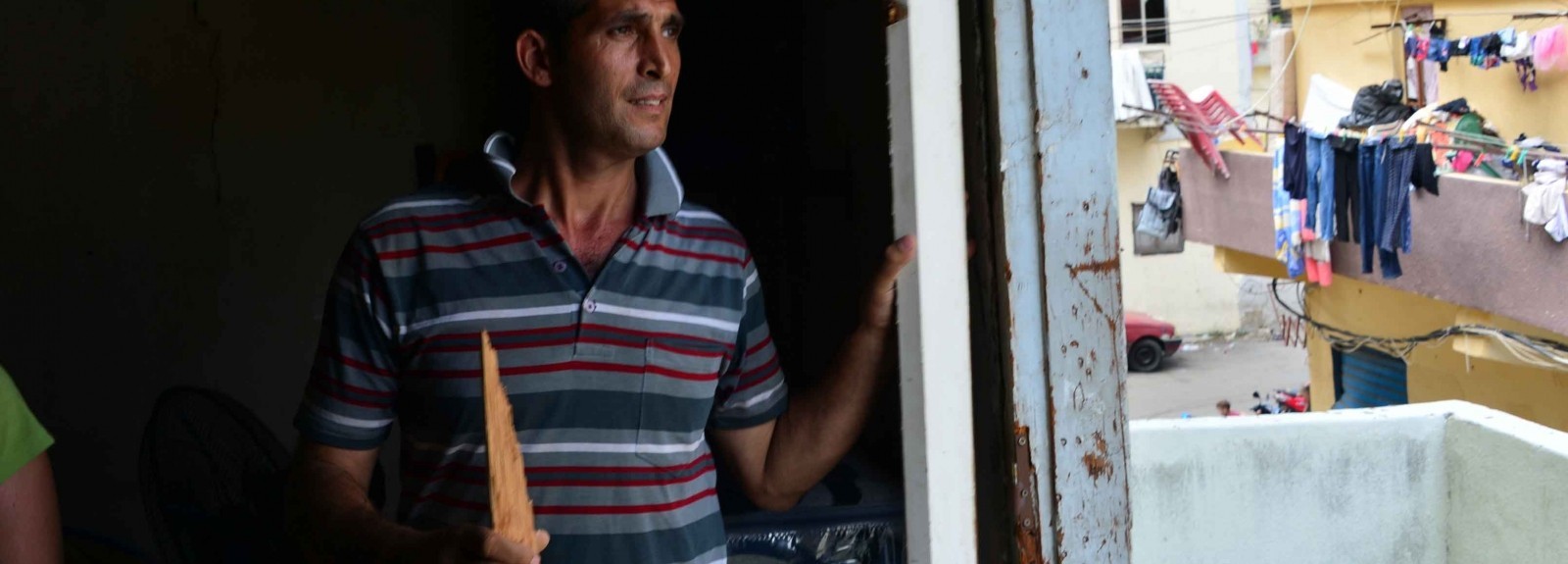 Khayrallah Warde, 40, was on his way home from Tripoli when he heard about the blast. His three children were at home in the family's two-room flat, and told him the doors blew in off their hinges. Unemployed, he says he cannot afford to fix the doors to his family's home. (Photo by Matt Hackworth/Corus International)