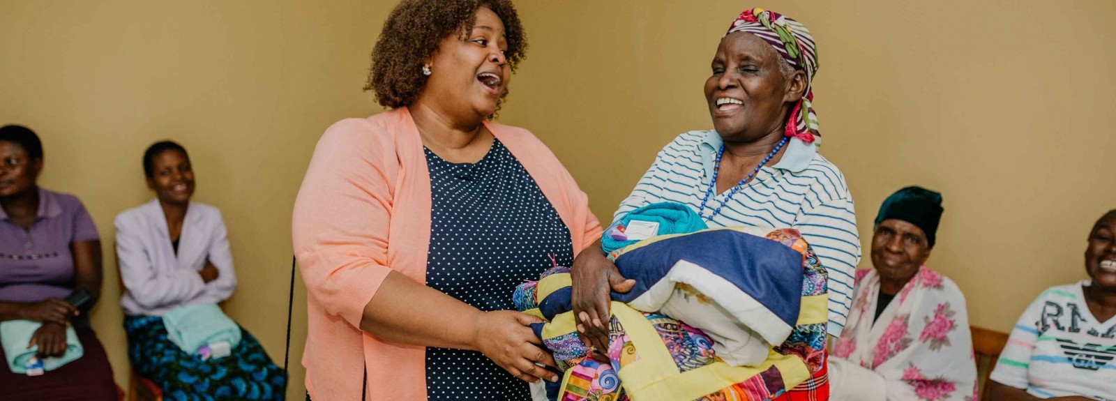 Lutheran World Relief Quilt & Kit Ministry Manager Janel Johnson-Momanyi shares a joyful moment with a Tanzanian woman during a trip in 2019. 