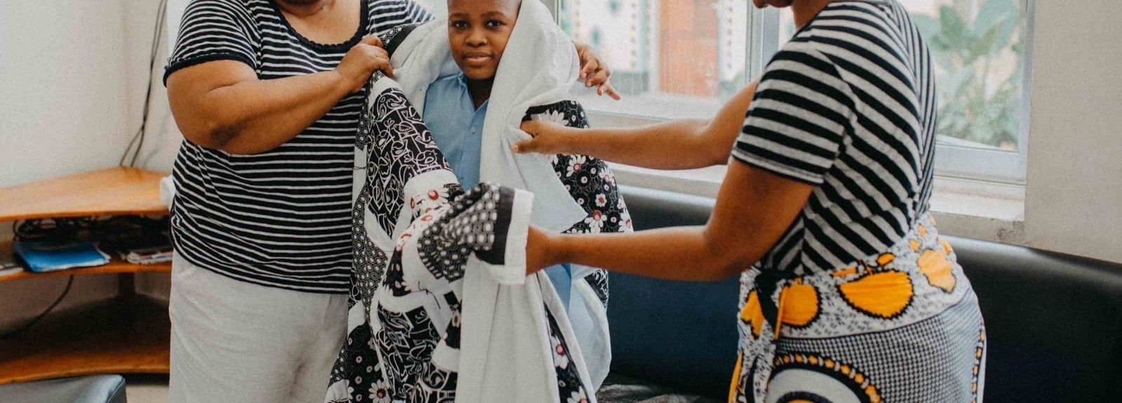 Janel Johnson-Momanyi, LWR Quilt & Kit Ministry Manager, had the unique opportunity to hand deliver a quilt made by St. James Lutheran Church in Gettysburg, PA, to Esther Anthony and her son Asaya Erasto Liguda during a January 2020 distribution at Muhimbili National Hospital in Tanzania. Esther and Asaya are living at the hospital while Asaya completes treatment for leukemia. Photo by Clemence Eliah.