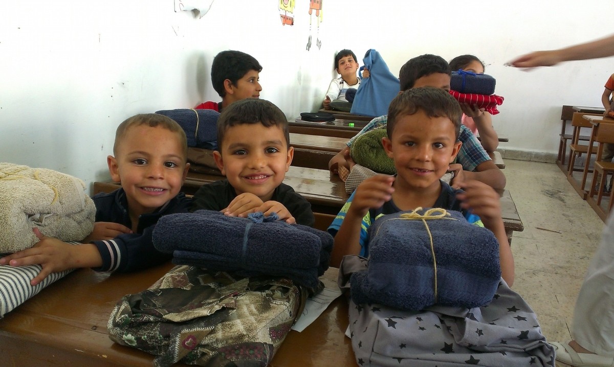 Syrian children enjoying their Personal Care Kits and School Kits they received at at the New Orthodox School in Jordan.