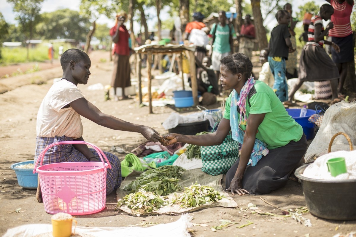 Akwanga Paulina (30, r) sells vegetables in the market that she cultivated with seeds and training from Lutheran World Relief in Palabek Refugee Settlement in northern Uganda.