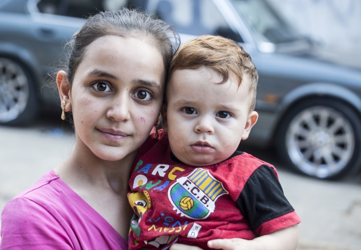 A woman and child stand outside outside the “AlWaha” center, a shelter for Syrian refugees living in Deddeh, a small town near Tripoli in Northern Lebanon.