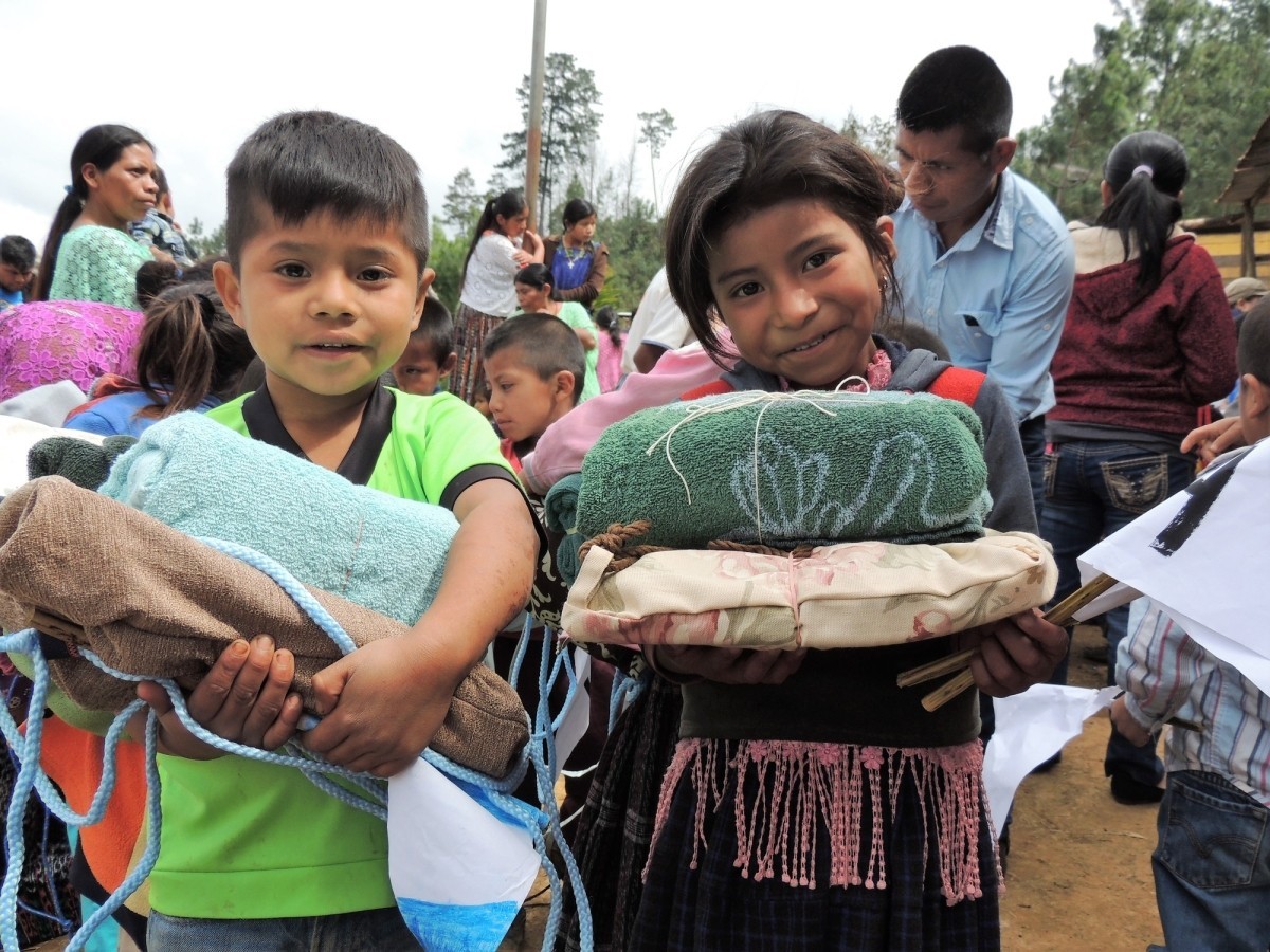 Students receive school and hygiene kits at Kaqlahib primary school in San Juan Chamelco, Coban, Guatemala.
