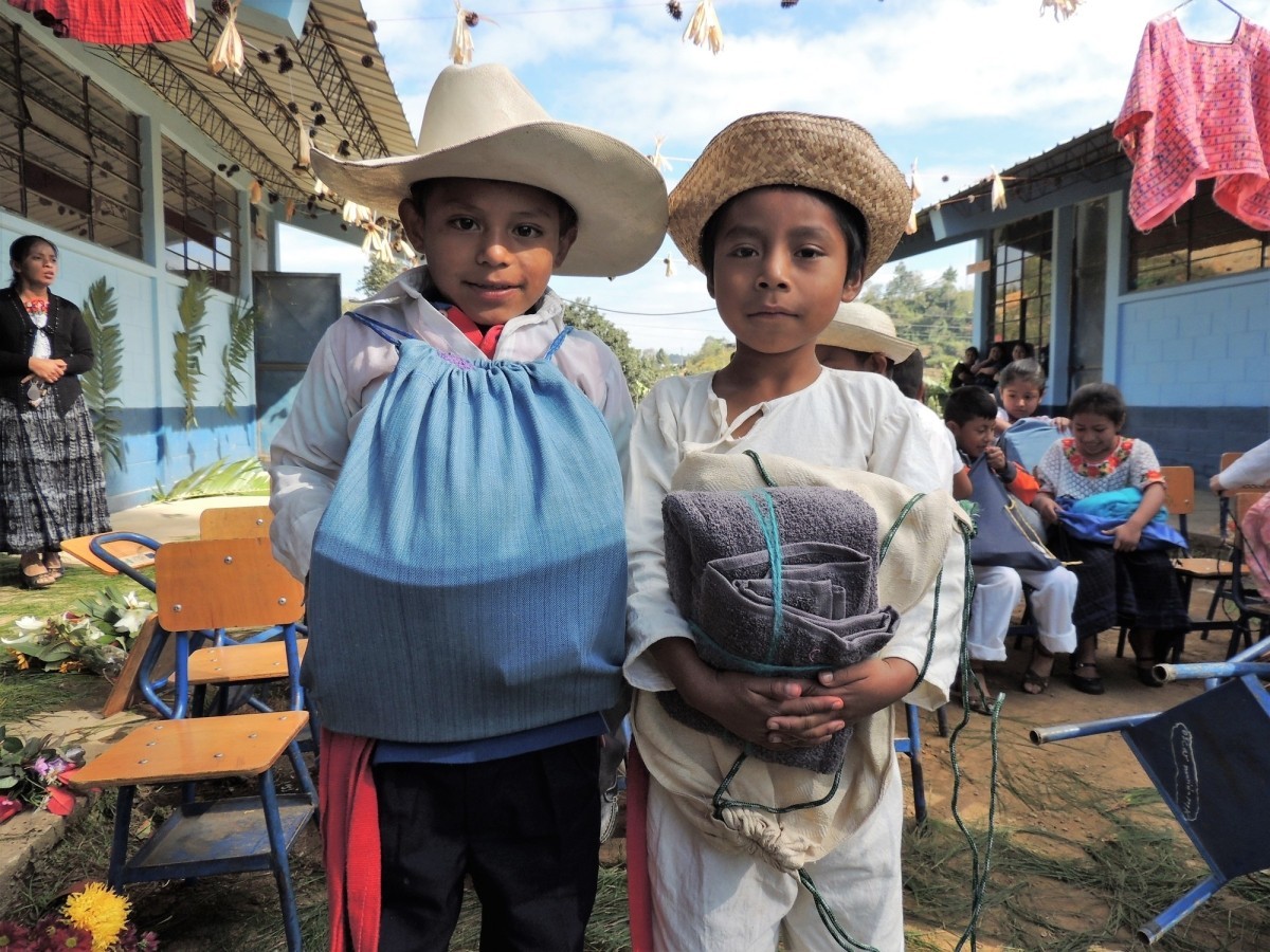 Students from Sesibche pose with their School and Personal Care Kits at distribution event.