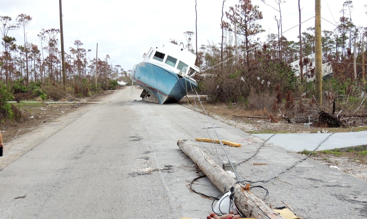 The storm surge swept this boat onto land, where it got tangled in power lines and blocked a road.