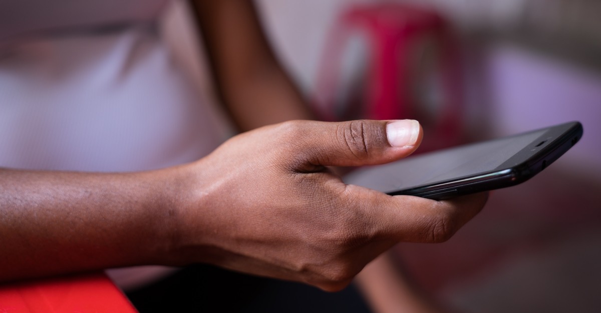 A hand holds a smart phone