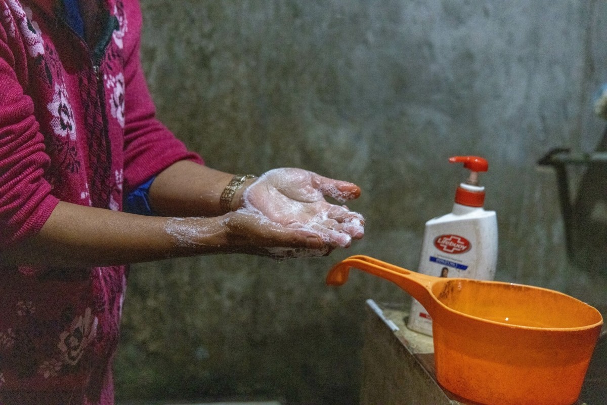 A woman washes her hand, advancing household WASH outcomes through Lutheran World Relief's MECIHO project