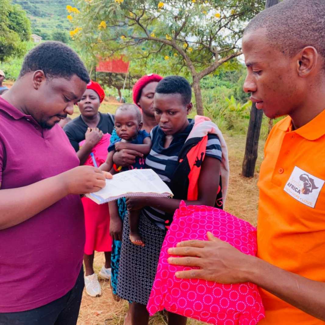 Staff from Smile for Africa distribute items to families, many of whose homes were destroyed in Cyclone Idai. (Photo courtesy of Smile for Africa)