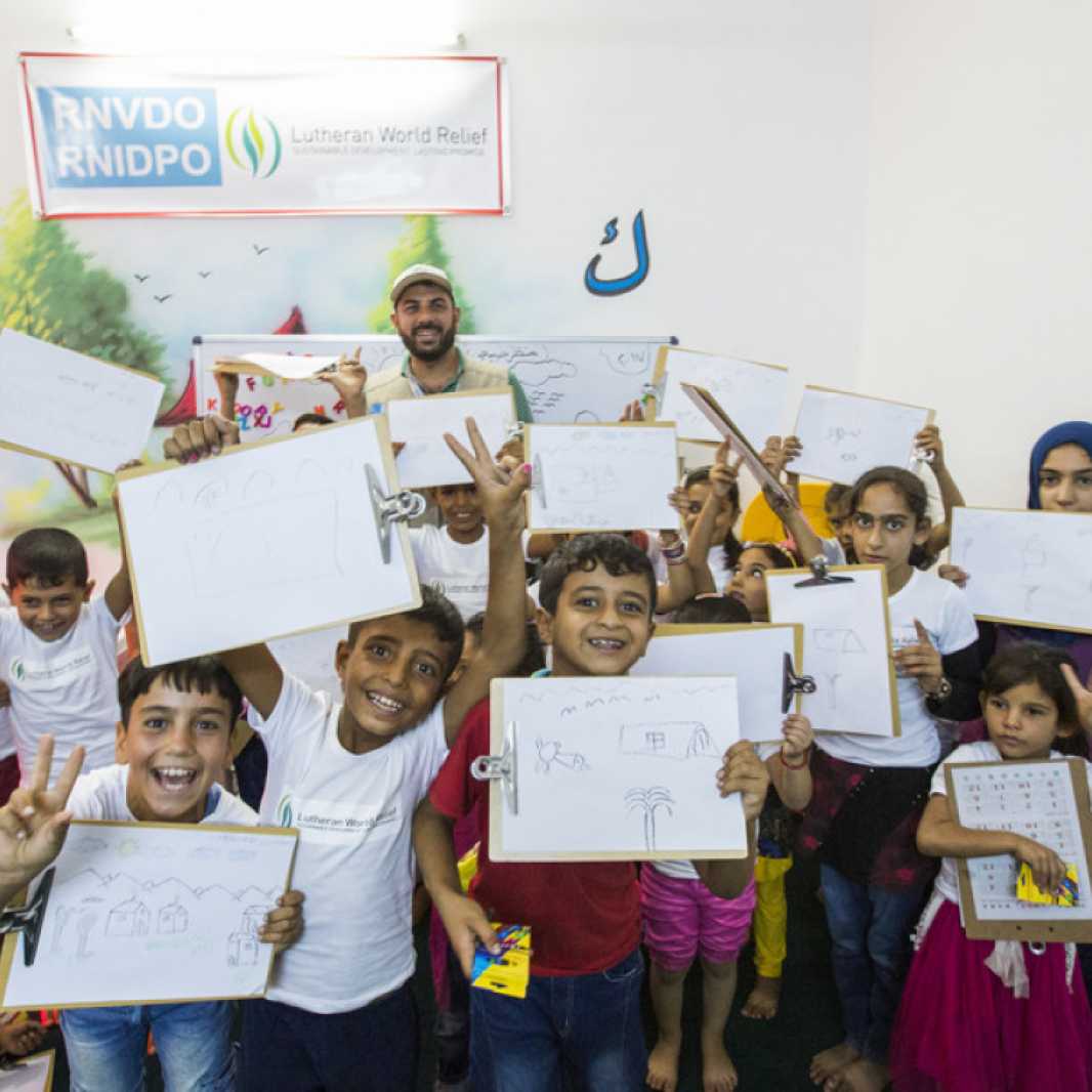 Dr. Orfan Muhammad (back, center) with children at the 