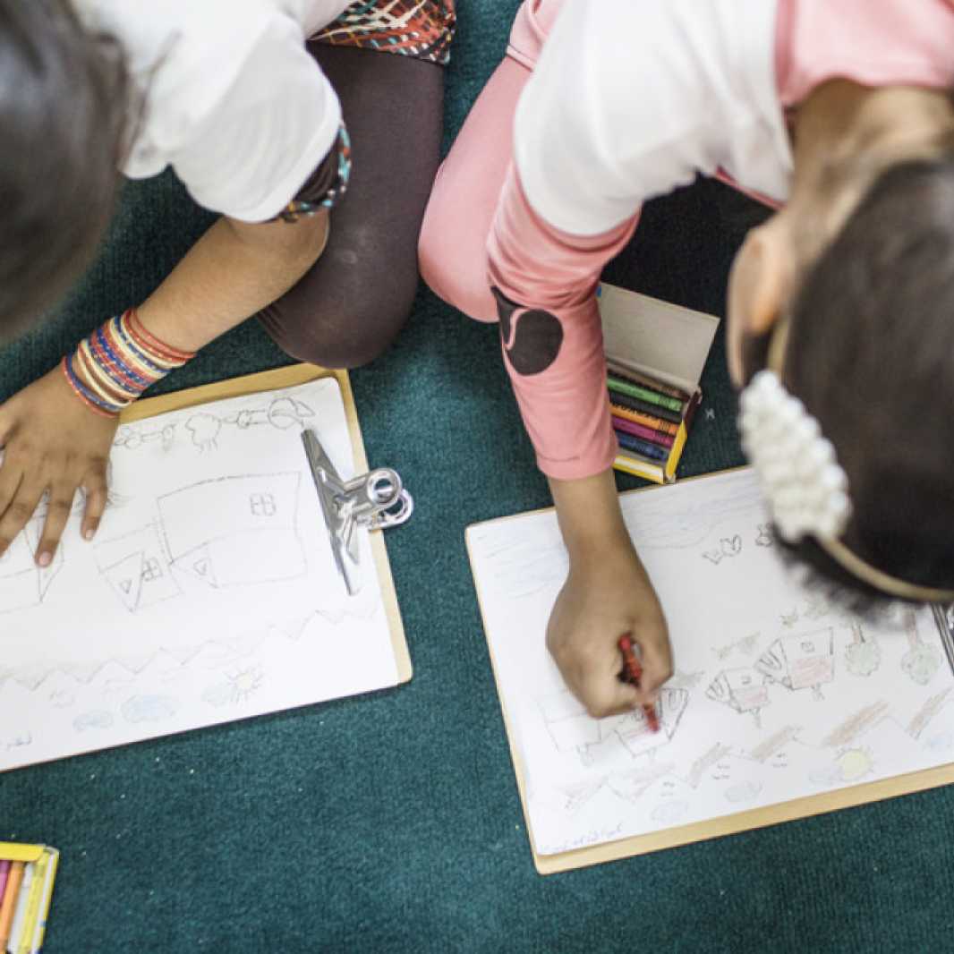 Children color, as part of LWR's psychosocial counseling program, at the 