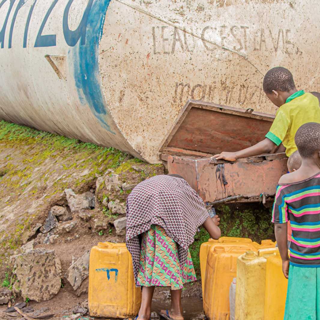 Children fill jerry cans with clean, safe water