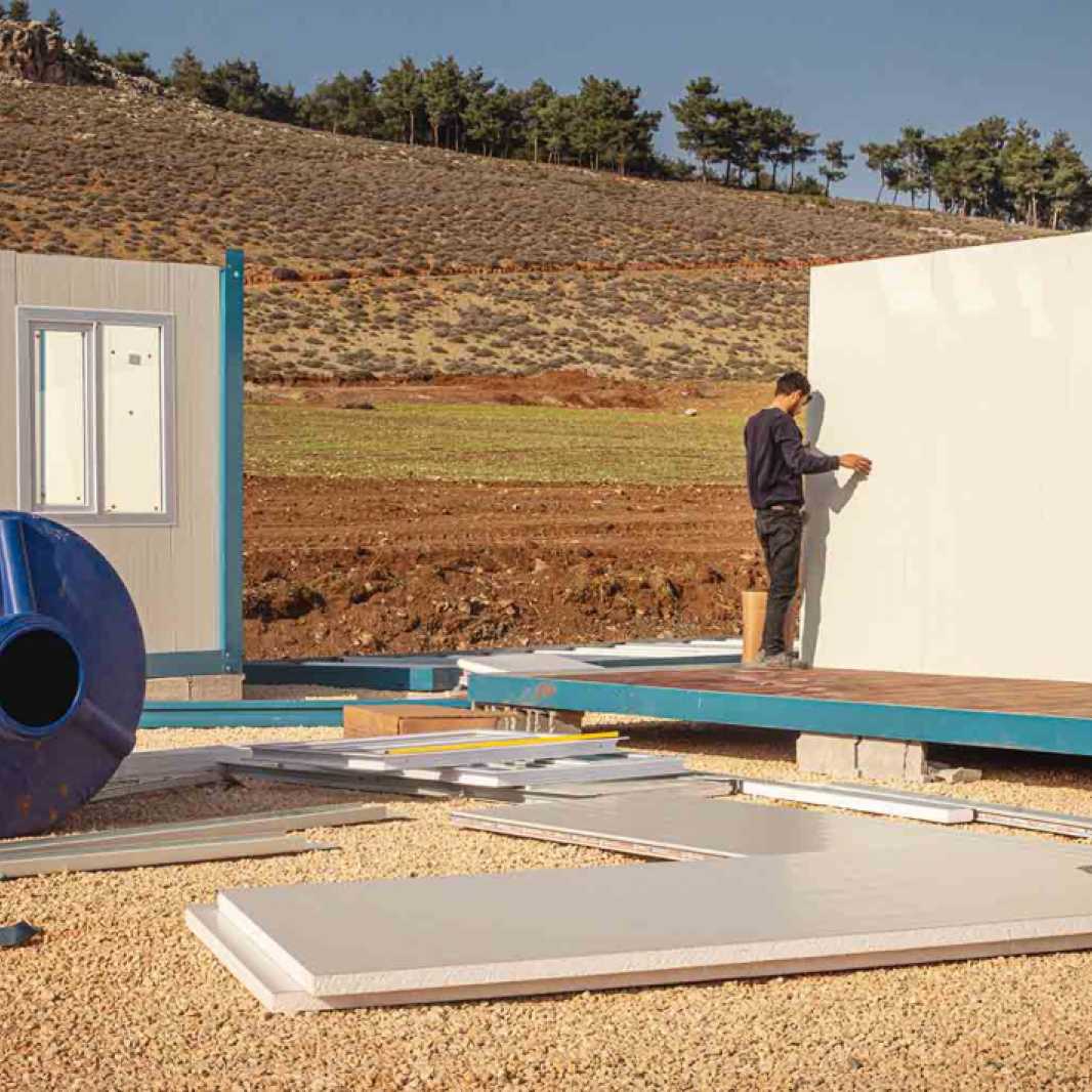 The container city will first focus on constructing staff housing and a community center where hot meals will be distributed to residents.