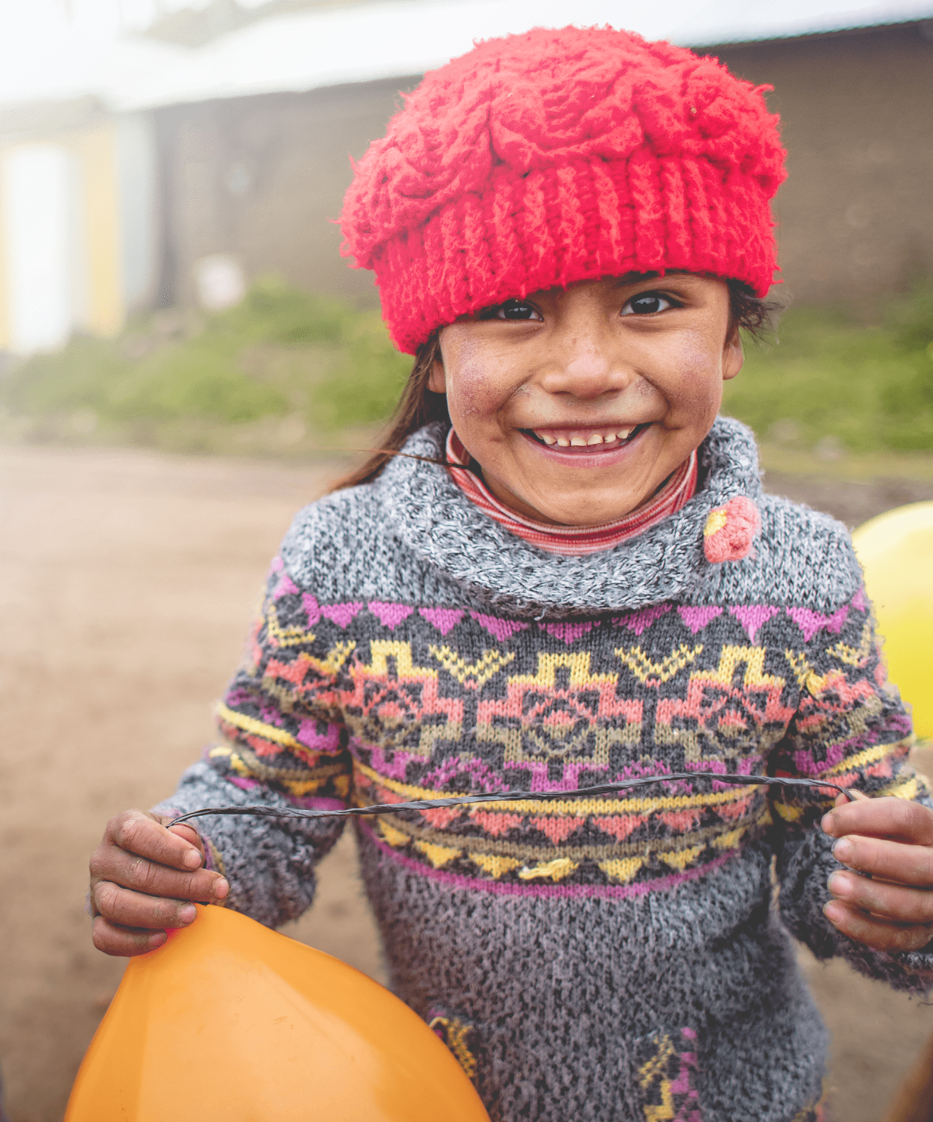 Children in the Cocha community in Castrovirreyna, Peru, preparing for a traditional Latin American celebration called Carnaval. Carnaval is celebrated during the week ahead of Lent. During the celebration, participants dance around a balloon-filled tree and take turns trying to chop it down. Whoever succeeds, must plan the celebration the following year.  In a high Andean region of Peru called Castrovirreyna, Lutheran World Relief supports a program led by partner Center for Integrated Community Development (CEDINCO) to reduce malnutrition. In eight communities over 12,000 feet above sea level, poverty and the harsh climate make it difficult for families to produce enough food. There, CEDINCO teams help indigenous families to grow nutritious food and improve the nutritional status of their children.    Earlier, the staple diet of the region was mainly grain and potatoes, with little protein. “The food was very poor,” says Irene Flores, CEDINCO’s director. Children suffered from chronic malnutrition and early childhood anemia.    Supported by LWR, CEDINCO's program helps families create mud-walled greenhouses to grow vegetables; raise guinea pigs and chickens for meat; and maximize their food production in other ways. They also provide trainings for mothers about the importance of good nutrition.    “The availability of food has increased and diversified,” in the program’s eight communities, says Irene.   In collaboration with Growing Hope Globally, LWR’s program increases yields of nutritious food by training indigenous farmers on organic production methods including establishing seed banks, improving post-harvest storage, and establishing family greenhouses. By strengthening small livestock rearing, families have greater access to meat. Farmers are also trained to market their organic potato and vegetable crops — for example, selling to organic potato-chip markets in Europe — and manage their farm income.   The program coordinates with educational institutions and health facilities to promote social and behavioral change that advances good nutrition and hygiene habits. Home visits raise awareness about anemia and parasites and teach children about the importance of washing hands. Families are also trained in keeping their homes clean by separating their small animals from areas where people eat and live.    LWR has also launched a COVID-19 vaccine awareness campaign in Castrovirreyna in collaboration with the local health posts.   LWR is supporting this work through the Promoci n de entornos favorables para la seguridad alimentaria y la nutrici n familiar en Castrovirreyna – Per  (Promotion of favorable environments for food security and family nutrition in Castrovirreyna – Peru) project. LWR has been working with CEDINCO since 2011 to improve food security, strengthen agricultural development, and support household health and nutrition in Castrovirreyna.    Photo by Amy Vu. Photo Releases: https://lwr.sharepoint.com/:f:/g/Emc654yswxdImo6YON1t0dwBeZzaSUW5sYpujACRth8TUQ?e=7qlGkm