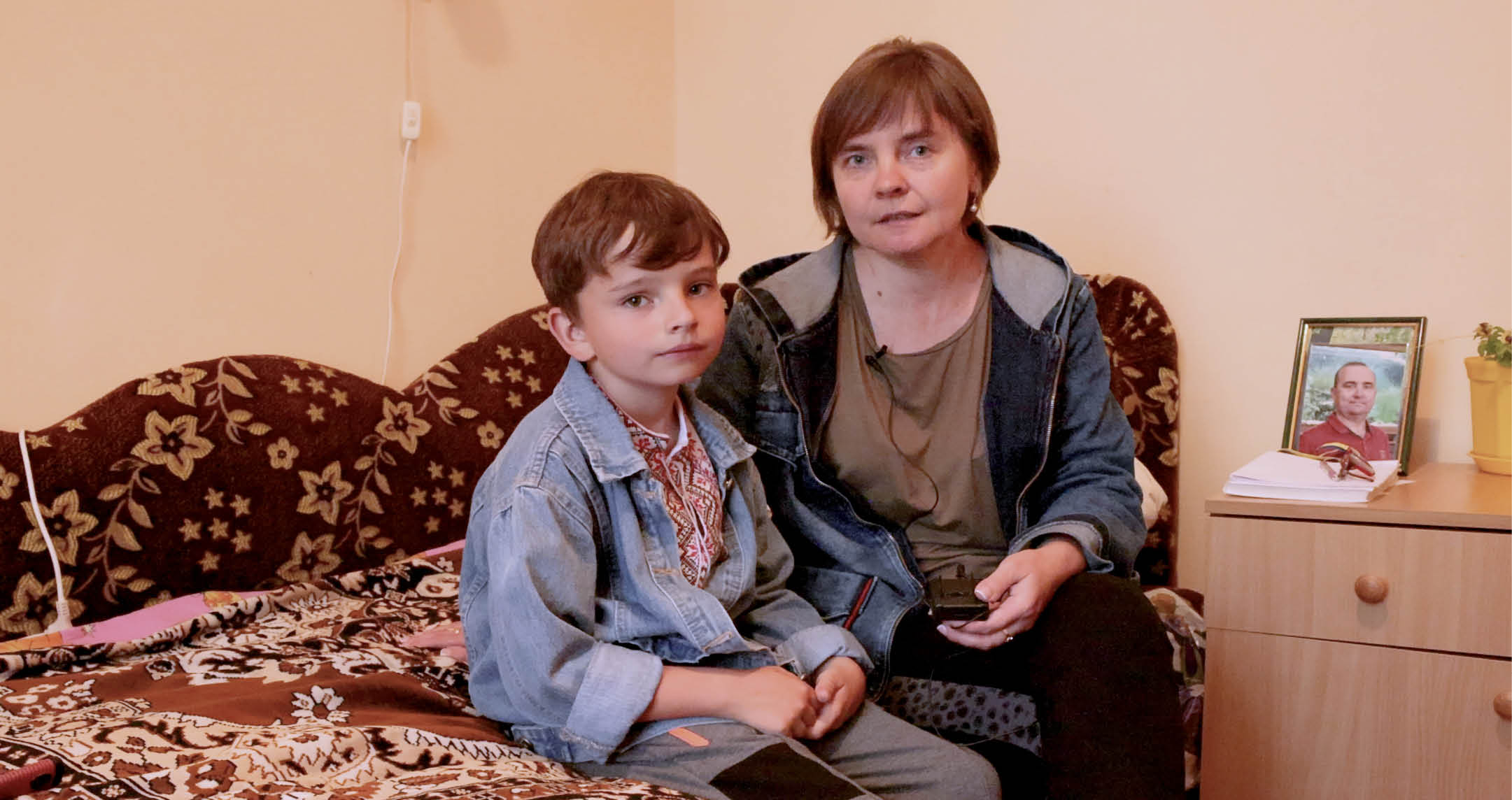 Ukrainian IDP Kamins'ka Ludmyla with her six-year-old son Svaitoslav Kaminskyj at the LWR quilt and kit distribution at the Morshyn sanatorium in Morshyn (Morshin), Lviv Oblast, Ukraine on the western side of the country. This particular sanatorium (medium-term IDP housing facility) saw a significant increase in the number of IDPs requiring free accommodation in late May 2022. Currently housing IDPs who have not returned to their homes due to active battles or destroyed homes. Mainly IDPs from Kharkiv, Lugansk, Kherson areas. Mostly, women with children, around 70 children.  Ludmyla and her son left their home in Donetsk because of nearby fighting. “Because I feared for my child's life, I decided to leave rather than stay there.” Ludmyla recalls. She says that the community of Morshyn has welcomed them “with open arms.”  All of the fees for Ludmyla and Svaitoslav’s to stay in this sanatorium and eat the meals that are served have been covered by Corus International.  She keeps a photo on their night table in their room in the sanatorium of Svaitoslav’s father who died six months before from Covid-19.  Ludmyla only wants to return home as long as the area they are from remains Ukrainian, she loves Ukraine and wants to raise her son in the Ukrainian nation.   On May 31, 2022, LWR Quilts and kits (school, baby, and personal care) were distributed at the Marshy sanatorium to IDPs by Corus International’s Chief Humanitarian Officer Tamara Demuria along with Program Manager Daniel Brown, Vice President of External Relations and Engagement Eddie Byrd and Senior Manager of Philanthropic Initiatives Maryna Zuy Hayes. The distribution was met with joy and appreciation.  Luybov Biliska, the Deputy Director for Legal, Personnel and Organizational Work at the Morshyn sanatorium says, “With the beginning of the war our Sanatorium became a great refuge for all citizens of Ukraine, who moved from territories on which active hostilities were conducted, or affected from active combat operations. We sheltered about 3,000 people since February 24, who needed protection, who left those territories came to us for a long stay, or short-term, in order to further go abroad.”  “The first days of the war they were very difficult for all of us. We worked seven days a week and almost without sleep. People drove anxiously, we cried with them, took in those frightened children. We don't like to talk about that, it is very difficult for us to think about it. We hugged them like family.”  There are currently about 300 people staying in the sanatorium. Since the start, 720 people have stayed free of charge. They had to quickly open all of their buildings that had been shutdown for the winter to accommodate the demand of IDPs who were seeing refuge since the very first day of the war.   “Since the situation changed in Kyiv, a lot of people returned to Kyiv, but we are hosting now those, who came from Lugansk, Donetsk, from Mykolaiv regions, those that are having heavier times right now. One of the buildings that Corus is sponsoring, we have 70 children.” Luybov continues. “There are many requests that come, but we are forced to refuse due to lack of funds.”  The building Corus is sponsoring is called “Svitanok,” which houses about 30-40 percent of the sanatoriums total IDPs.  “We are planning in stages offer a medical base, although the prospect is disappointing because people who need shelter today such, cannot all allow treatment, although we provide them with first aid and they are provided with medical care in the municipal hospital,” says Luybov.  Through the month of March, the sanatorium was covering all of its own costs to house IDPs. They are grateful for Corus’ support in more recent weeks. The sanatorium is still covering the costs of everyone outside of the Svitanok building.  “Thanks to Corus we have the opportunity to receive our citizens today, provide them with proper living conditions. They were warmed – we paid for gas supply services, heat supply, provided with cold and hot water, provided with three meals a day, they have the right conditions,” says Luybov.  “Children in the early days asked for all bomb shelters … The only thing they were interested in: where is your bomb shelter? If you look at these people now, these are completely different faces. There is peace, there is a gleam in their eyes that we see and we are happy that we're able to help these people,” says Luybov. According to OCHA’s situation report published on June 24, 2022, there are 7.1 million IDPs as a result of Russia’s invasion of Ukraine on February 24, 2022, and the ensuing war.  As of June 3, 2022, LWR is partnering with the Federation of Trade Unions of Ukraine (FPU) to support six union-run centers that are being used for temporary housing. We’re helping more than 15,000 internally displaced persons (IDPs) forced to flee heavy fighting in the eastern and southern parts of the country with no other means of support. We are also providing toys for children, food and essential supplies and equipment, like folding beds, pillows, heaters, laundry detergent, toilet paper, and person hygiene items.  According to OCHA’s situation report published on June 24, 2022, there are 7.1 million IDPs as a result of Russia’s invasion of Ukraine on February 24, 2022, and the ensuing war.