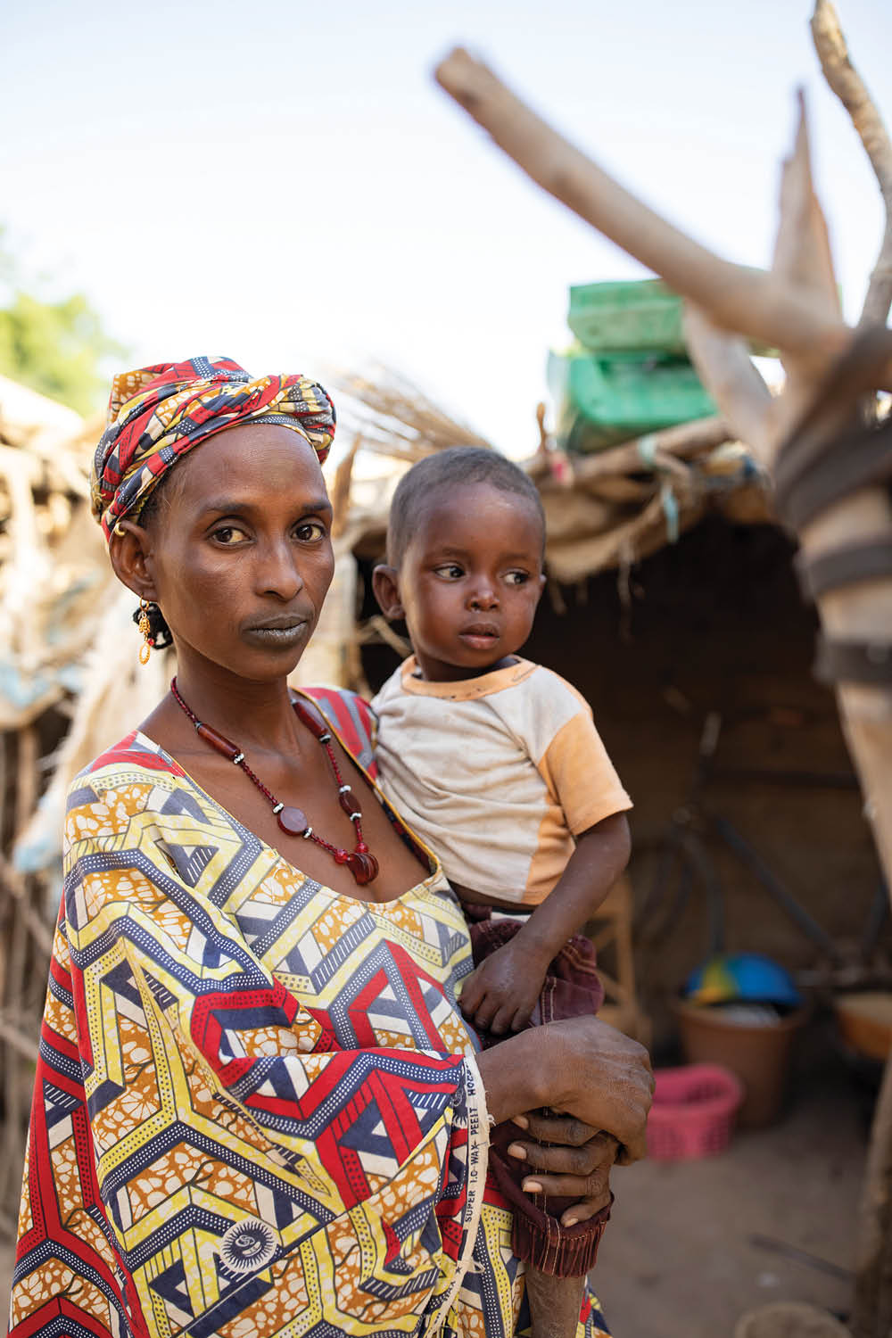 Aichata Sidibe, shown here with her son Alaye (2), is the mother of three children, who is expecting a fourth  They live in a small, single room hut in the village of Siemana, Mali, while her husband has left the area to find work  Finding enough food to feed the family presents a constant challenge, and the children are often hungry   When the children don t get food they get sick,  she said   It s not for very long but I have to then rely on God    Sahel 2021 Crisis; Barouéli Cercle, Mali  Feb 23, 2021  Photo by Jake Lyell 
