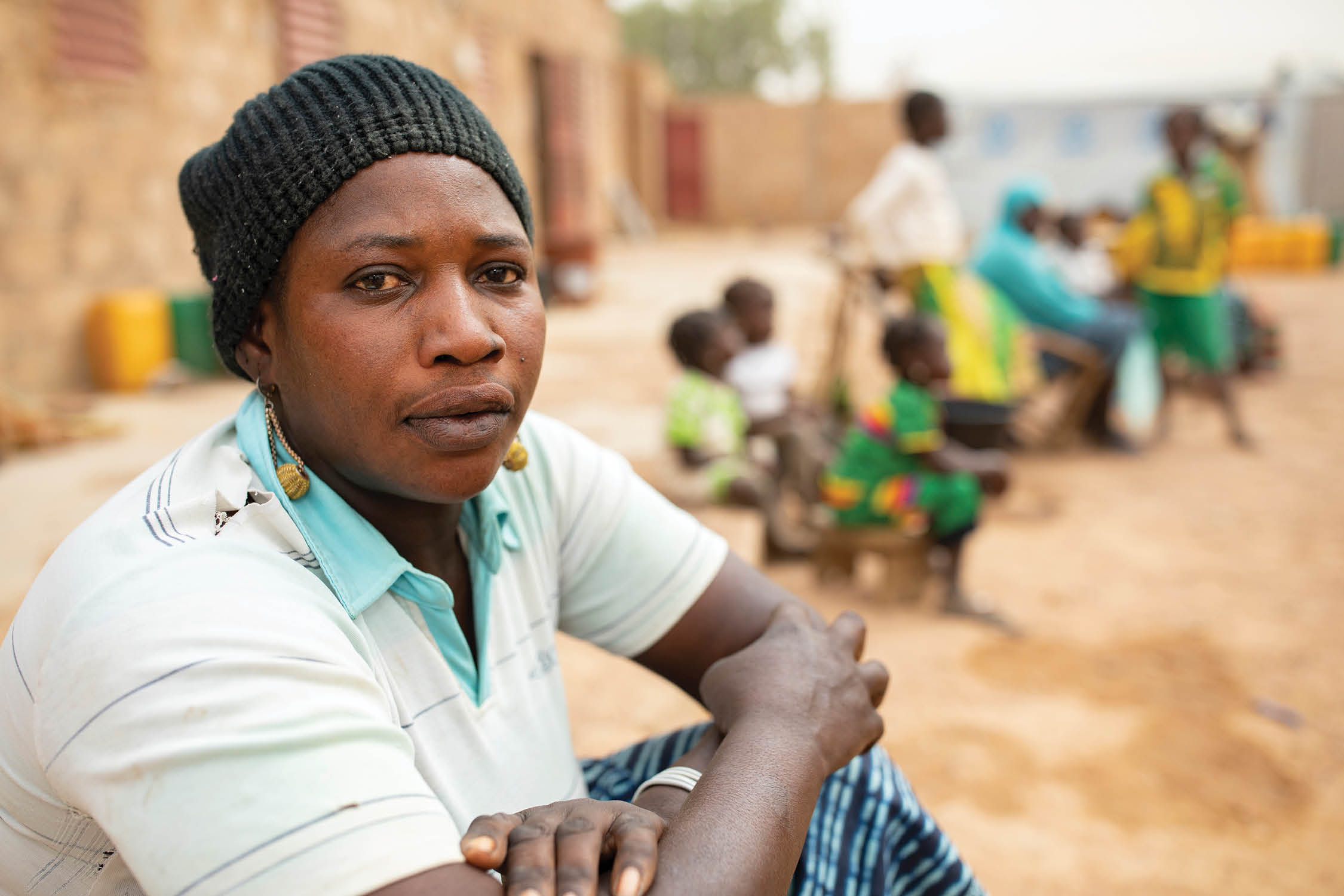 Sawadogo Ramata (33) sits outside her rented house in Nouna, Burkina Faso  She and her family fled violence and insecurity to shelter in Nouna and now face hunger and food shortages  Sahel 2021 Crisis; Kossi Province, Burkina Faso   Feb 18, 2021  Photo by Jake Lyell  