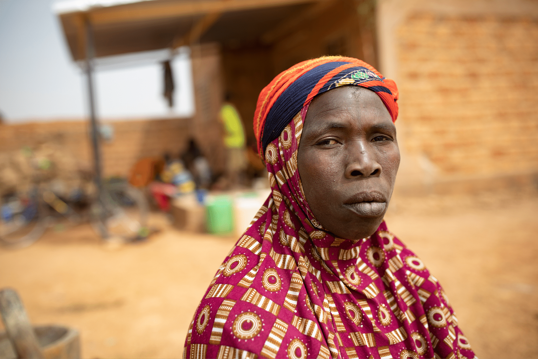 Yaoumou Arama (50 s) fled violence and insecurity in the north east of Burkina Faso and now live as IDPs in the western town of Nouna  Yaoumou is the sole breadwinner of her family of seven and brings in a meager living by cooking and selling snacks and meals to the neighbors  Her elderly husband is ailing and unable to work  Her youth and adult children are unable to find jobs  Living on a small, rented compound, with nowhere to farm, the family struggles with hunger and earning enough money to buy food   I m not enjoying life here,  she says   There is no place to work  If I could farm here life would be better    Sahel 2021 Crisis; Kossi Province, Burkina Faso   Feb 20, 2021  Photo by Jake Lyell 