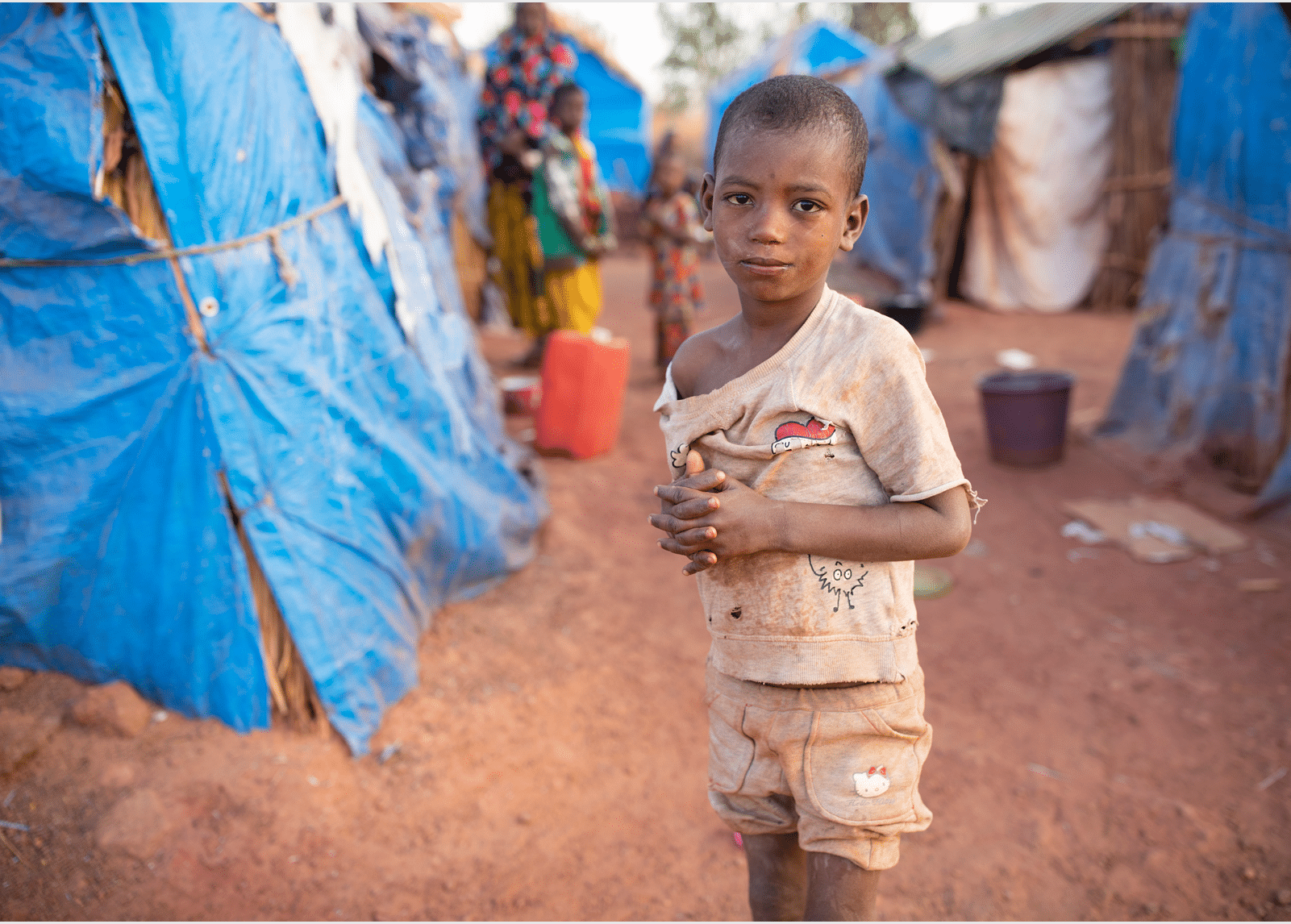 Senou Camp sits on the southern edge of Bamako, Mali s capital city  It is one of eight such informal camps around the city and, by itself, is home to 223 families and just over 1,000 IDPs  The families living here have fled violence and insurrection in the north and central parts of the country  Because most of them have no means of income or regular food source, hunger is a daily challenge and malnutrition among its population remains rife    Here, seven-year-old Saido Diallo stands outside his family s shelter   Sahel 2021 Crisis; Senou, Mali  Feb 24, 2021  Photo by Jake Lyell 